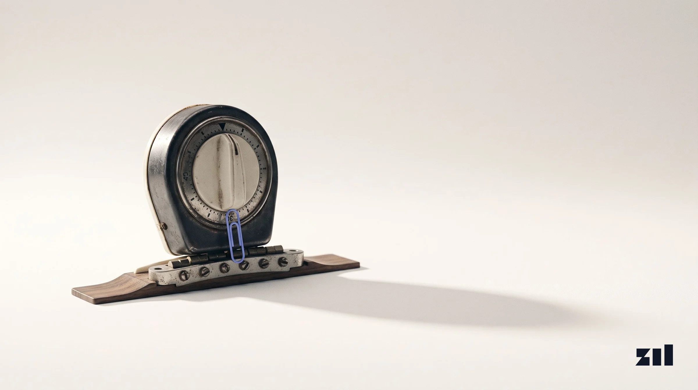 Vintage kitchen timer on a guitar bridge with a blue clip