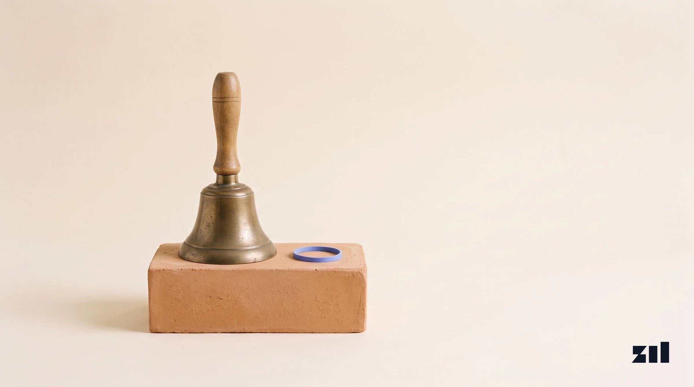 Campana de bronce sobre ladrillo, simbolizando una alianza en consultoría de marketing.