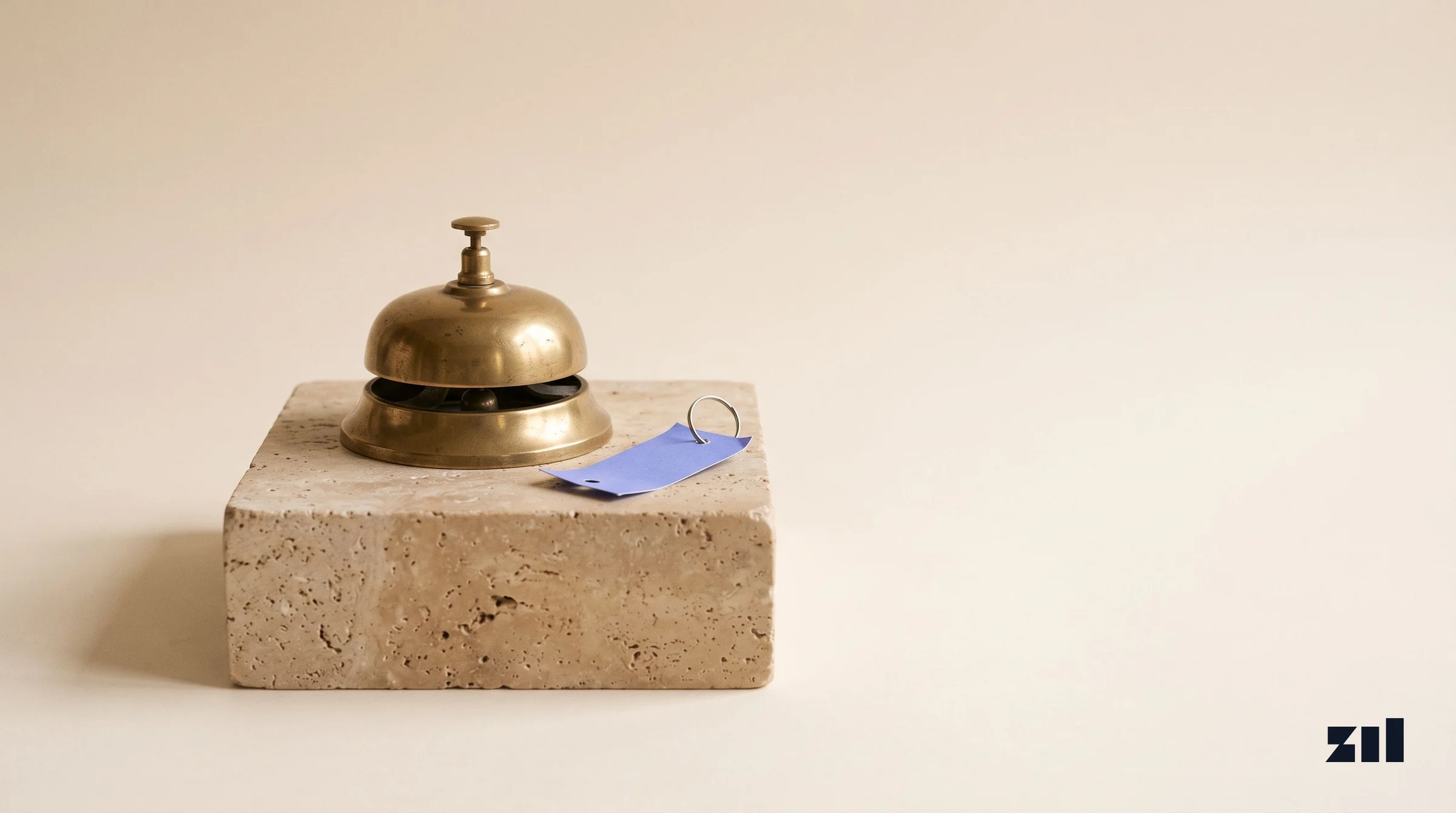 Brass desk bell on stone, symbolizing strategic career transformation in pop star rebranding.