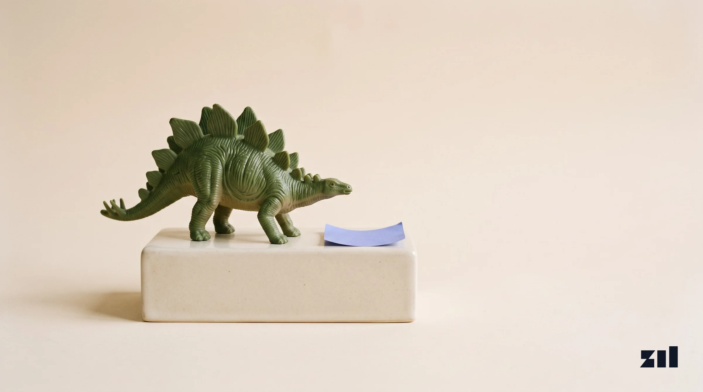 Green toy dinosaur on stoneware, illustrating outdated sustainability strategies in food marketing.